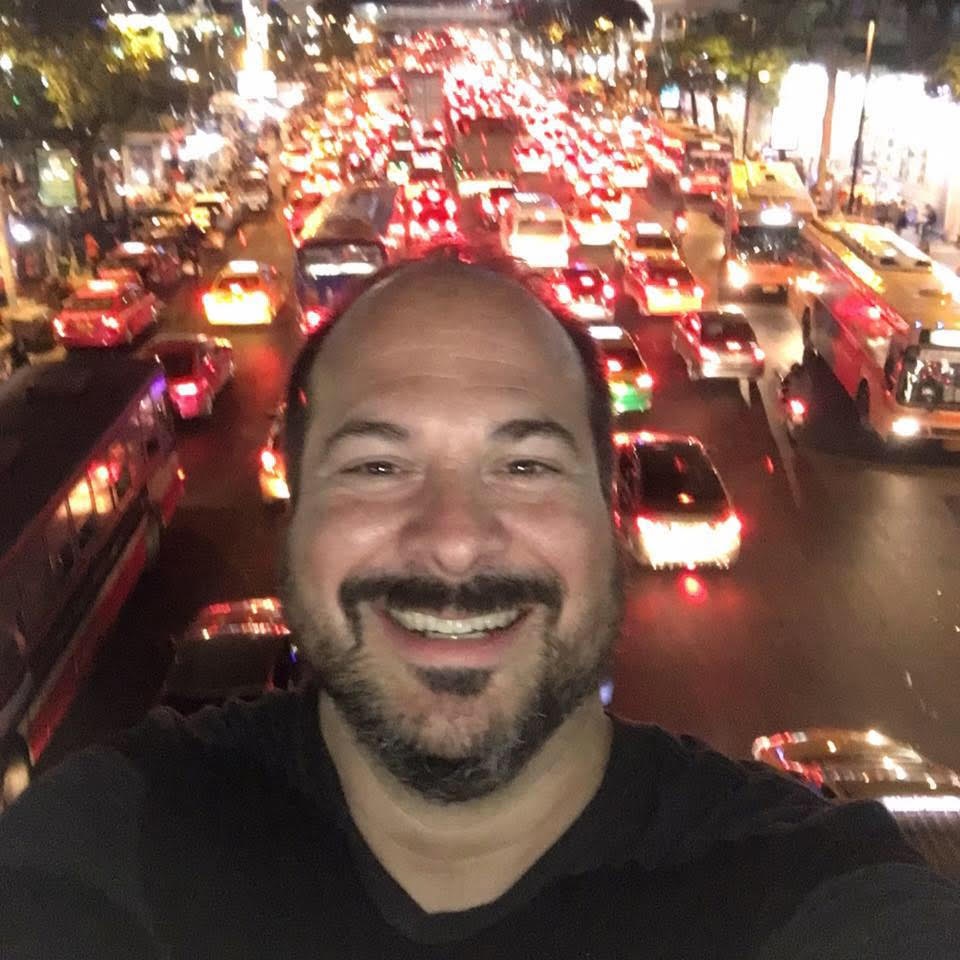 Kevin selfie in front of busy night road